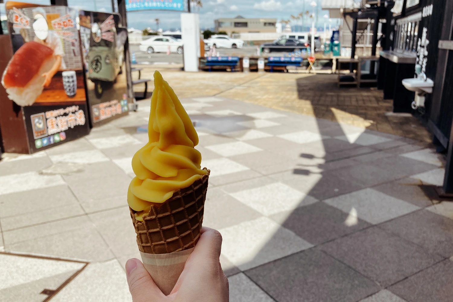 orange soft serve in a waffle cone