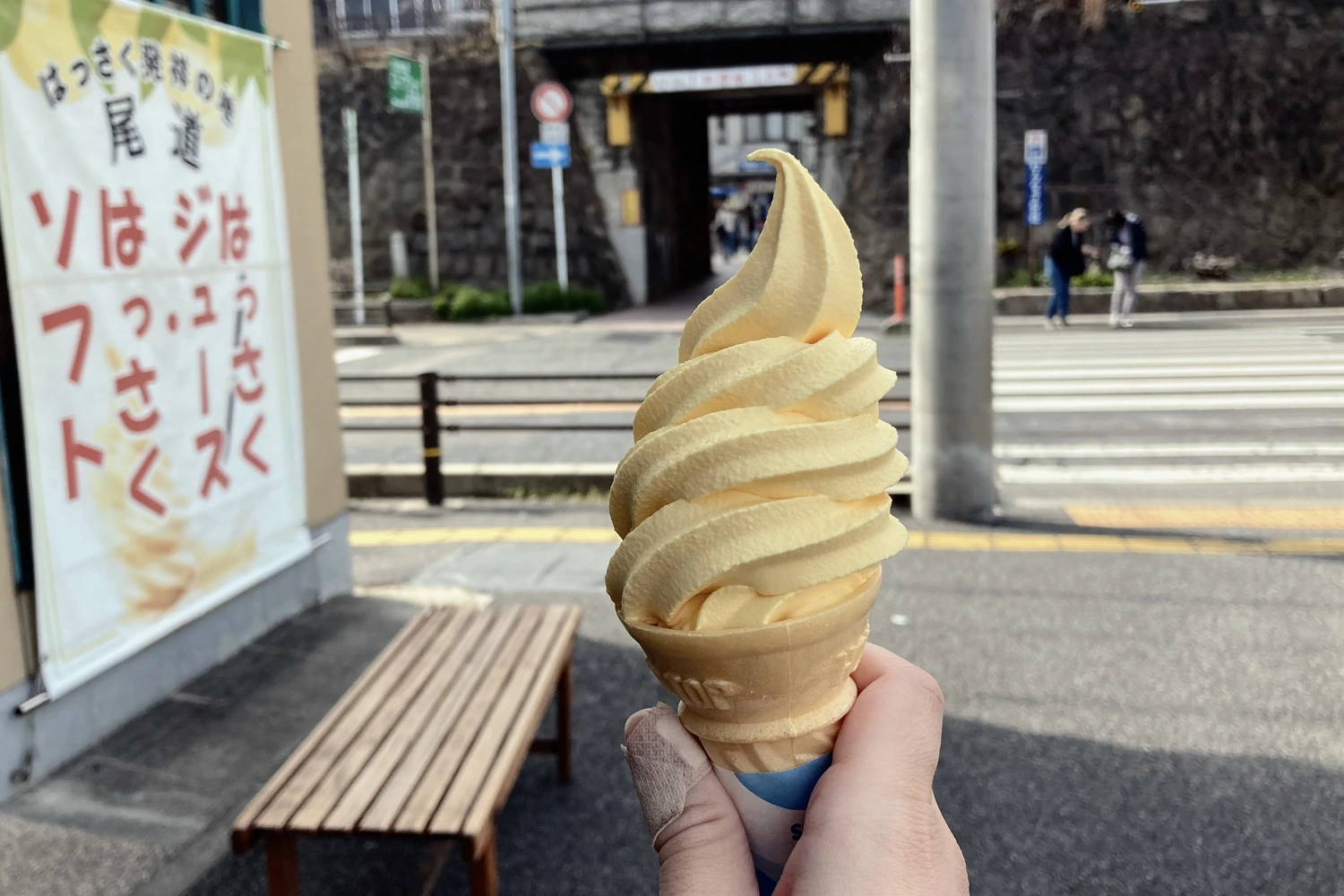 yellow soft serve in a wafer cone