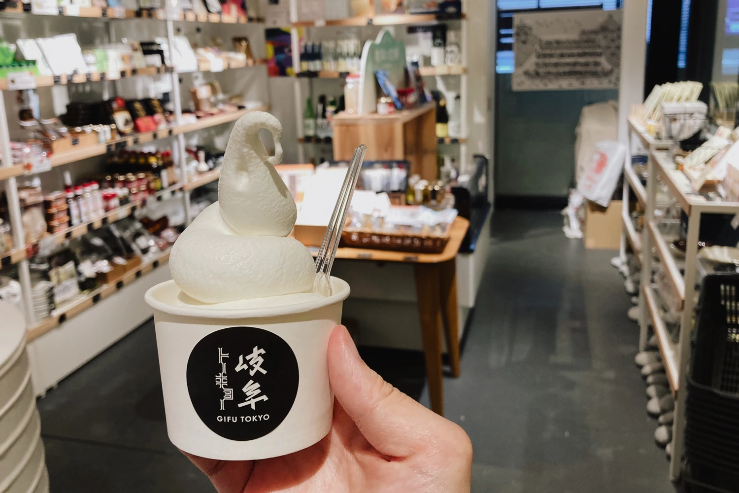 white soft serve in a cup, inside a store