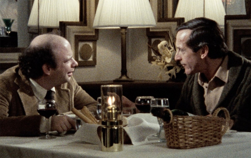 screenshot from the film 'my dinner with andre'. two guys are having dinner together at a restaurant.