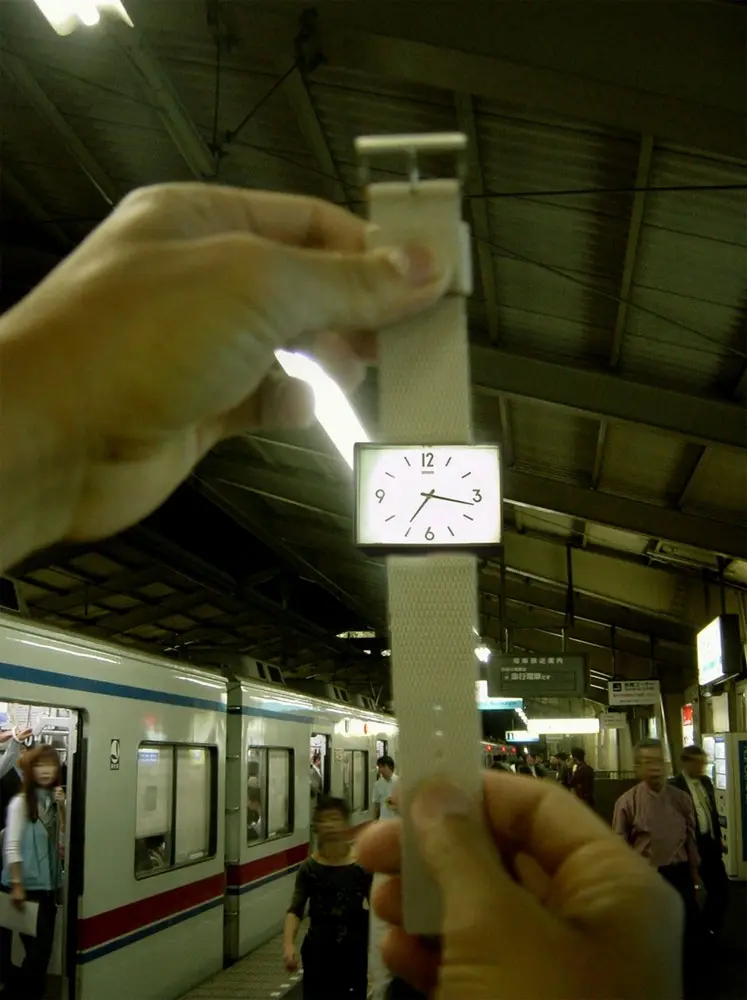 a simple wristwatch with a rectangular face. it's designed to look like the clock at a train station.