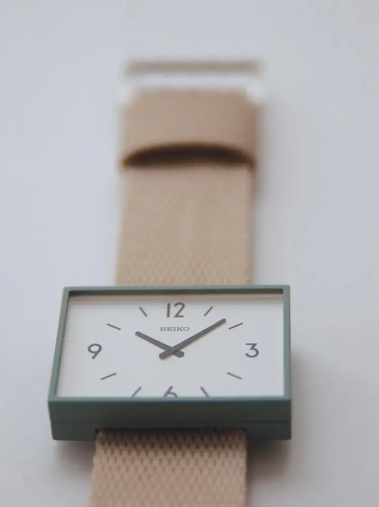 a simple wristwatch with a rectangular face. it's designed to look like the clock at a train station.